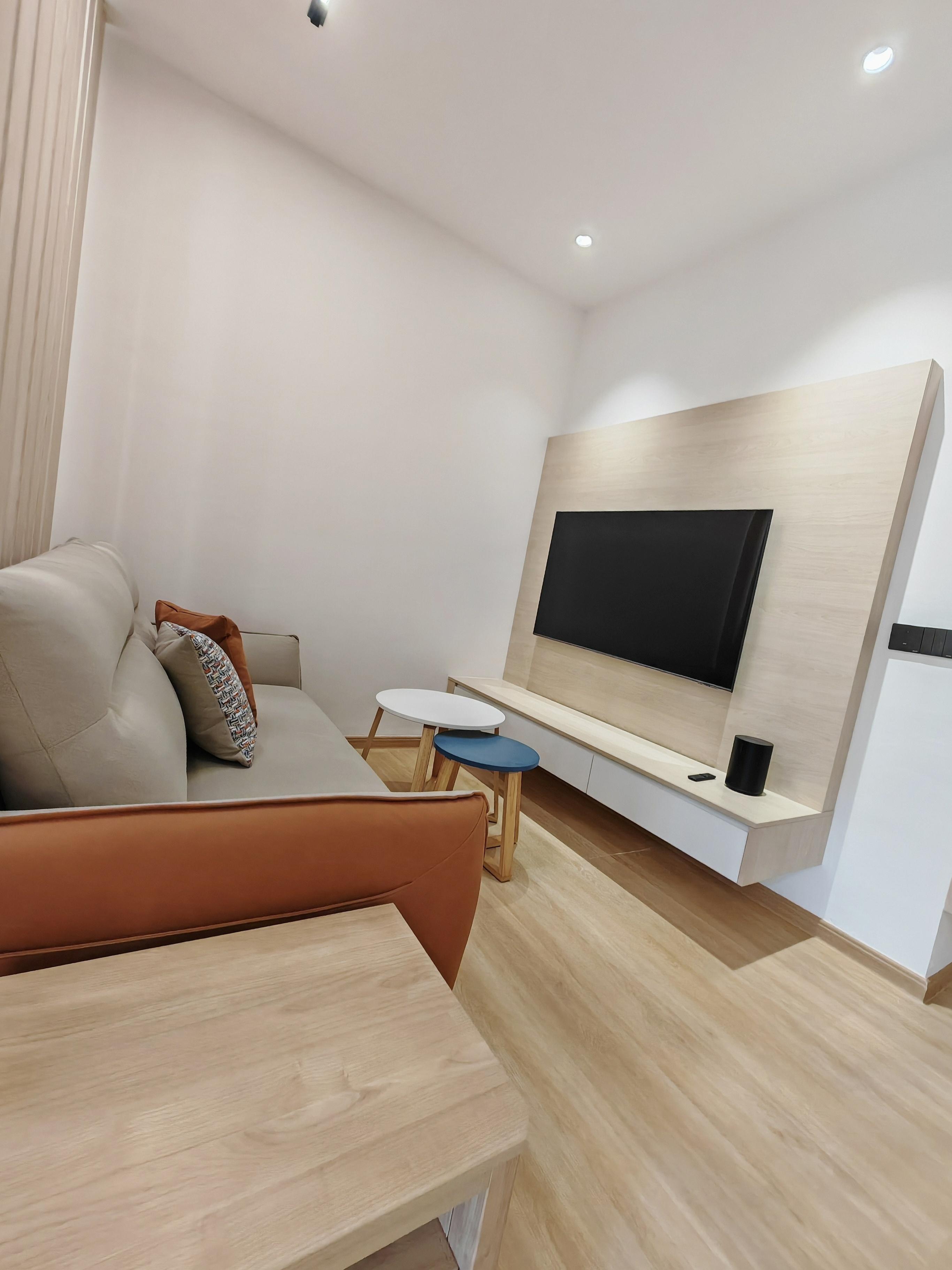 Completed living area with TV feature wall and built-in console